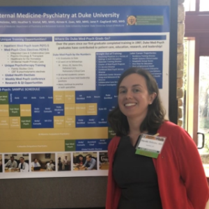Med-Psych residents Alissa Stavig and Nicole Helmke standing in front of poster